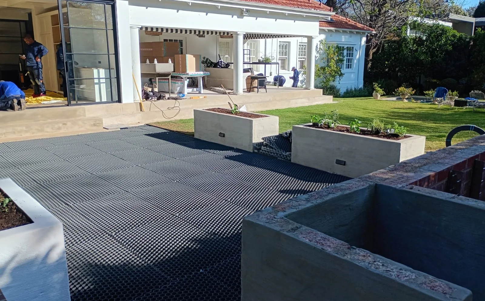 Sheets laid and trimmed in around the cast concrete planters.