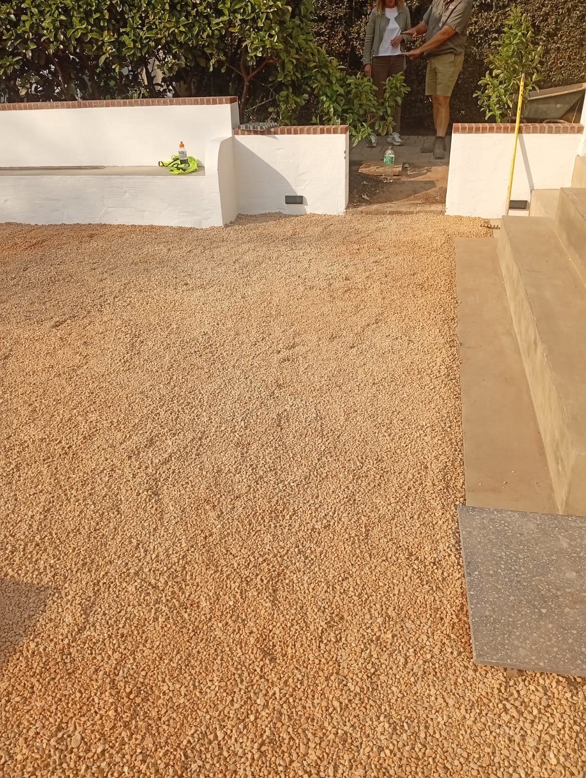 Finished surface, flush and clean-edged against the concrete step.